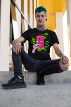 Load image into Gallery viewer, goth man sitting on stairs wearing a T-shirt MASKED black T shirt with grunge pink ski mask with  cross motif on figure design in alt style

