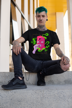 Load image into Gallery viewer, goth man sitting on stairs wearing a T-shirt MASKED black T shirt with grunge pink ski mask with cross motif on figure design in alt style