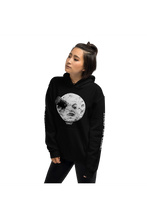 Load image into Gallery viewer, Black unisex hoodie with alternative fashion rocket in moon's eye from George Melliés' film Trip to the Moon with the original French title Voyage Dans La Lune 1902