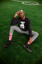 Load image into Gallery viewer, sitting on the grass man wearing black longsleeve T-shirt with goblin & three eyes cat