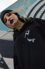 Загрузить изображение в средство просмотра галереи, girl wearing goth black hoodie with vintage victorian style girl split in two  aesthetic style unique fashion design top right logo in front name DIVIDED
