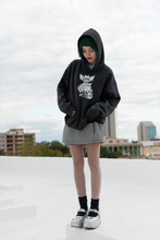 Load image into Gallery viewer, goth girl wearing black hoodie with three eyed mutant cat and armoured battle monster alt fashion design named THE CAT &amp; THAT 
